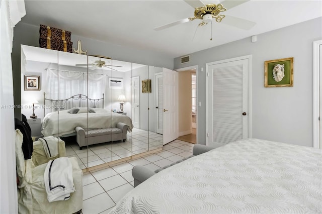 bedroom featuring ceiling fan, visible vents, and light tile patterned flooring