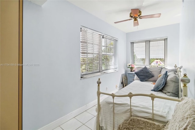 bedroom featuring ceiling fan, baseboards, and light tile patterned floors