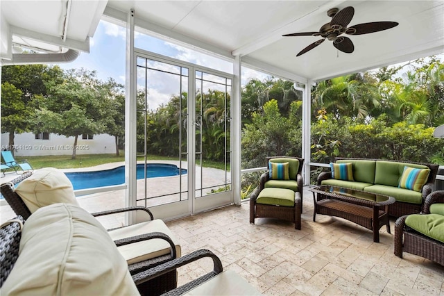 sunroom / solarium with a ceiling fan