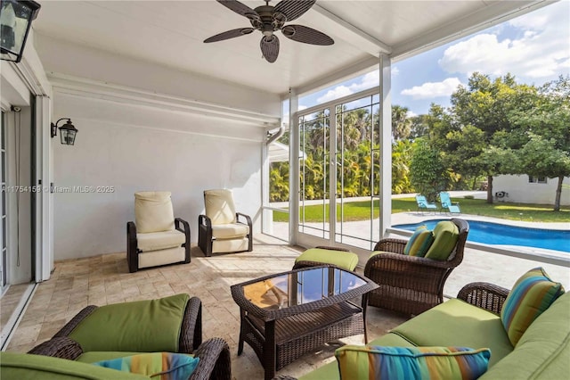 sunroom / solarium featuring a ceiling fan