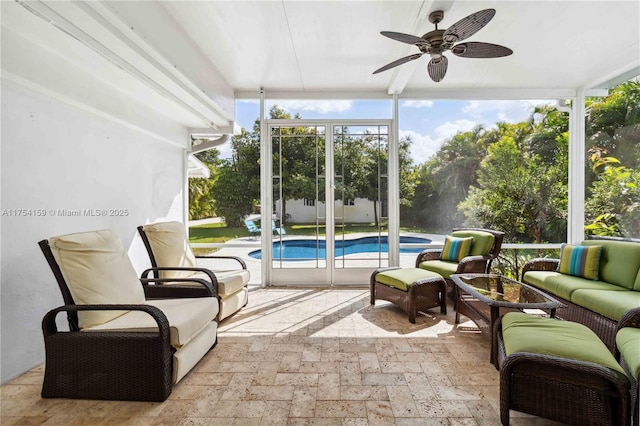 sunroom featuring ceiling fan