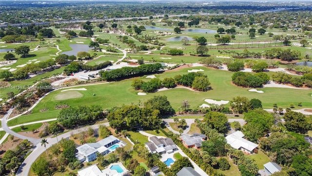 aerial view featuring golf course view, a water view, and a residential view