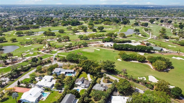 drone / aerial view with view of golf course, a water view, and a residential view