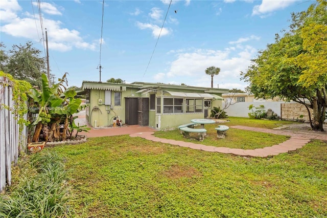 400 S 62nd Ter, Hollywood, FL 33023 - rear view of house with a lawn, a patio area, a fenced backyard, and stucco siding
