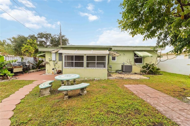 400 S 62nd Ter, Hollywood, FL 33023 - rear view of house featuring a yard, a patio, stucco siding, central AC unit, and fence