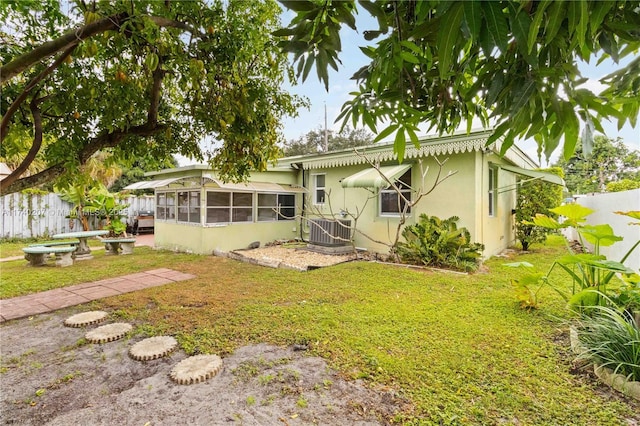 400 S 62nd Ter, Hollywood, FL 33023 - back of property with a sunroom, fence, a lawn, and central air condition unit