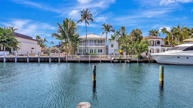 view of dock with a residential view and a water view