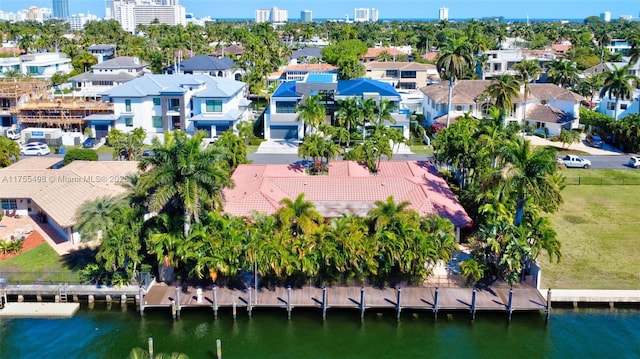 aerial view with a residential view, a water view, and a view of city