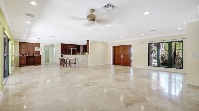 unfurnished living room with visible vents, baseboards, and crown molding