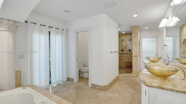 full bath featuring visible vents, a sink, a shower stall, a garden tub, and toilet