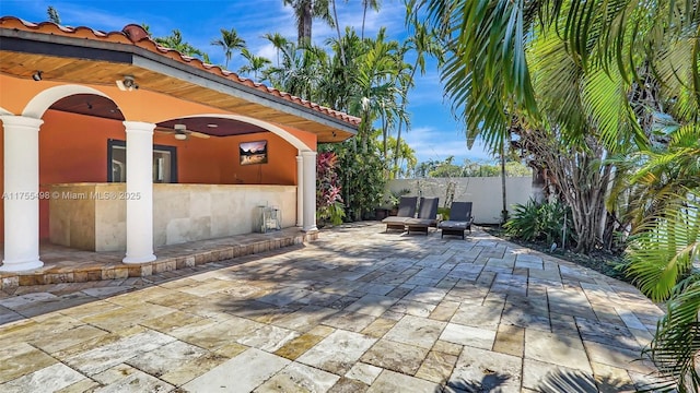 view of patio with fence and ceiling fan