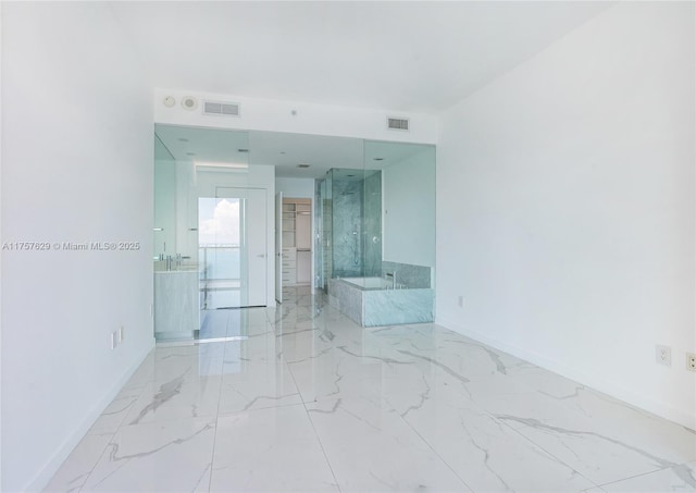 unfurnished room with marble finish floor, baseboards, and visible vents