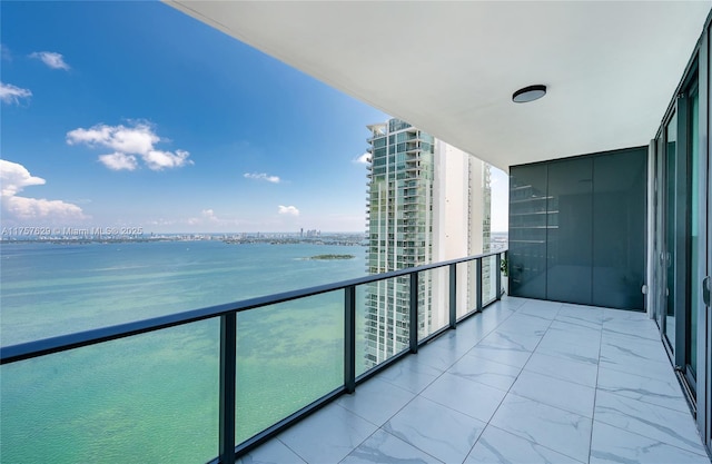 balcony featuring a water view and a view of city