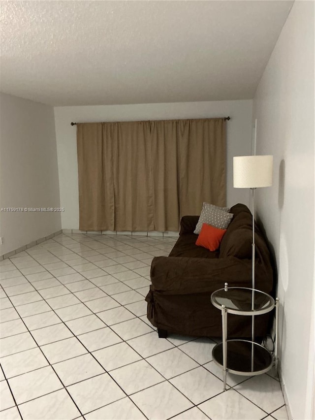 living room featuring light tile patterned flooring and a textured ceiling