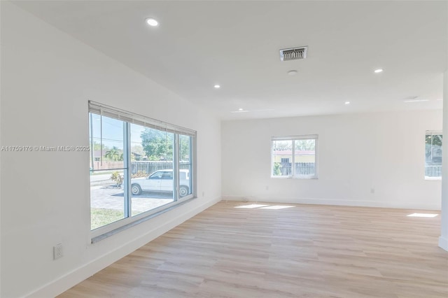 spare room with light wood-style floors, baseboards, visible vents, and recessed lighting