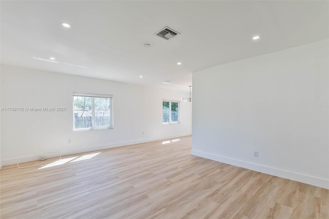 empty room with recessed lighting, visible vents, light wood-style flooring, and baseboards