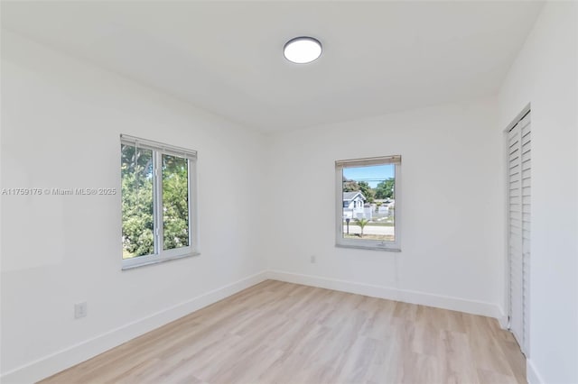 unfurnished bedroom with light wood-style floors and baseboards