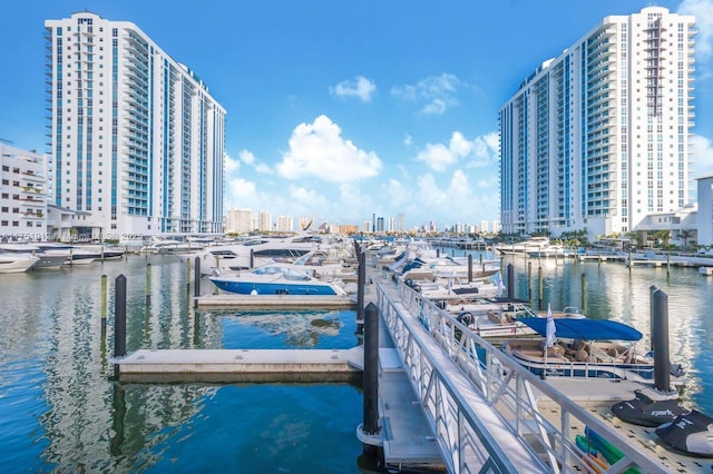 view of dock featuring a view of city and a water view