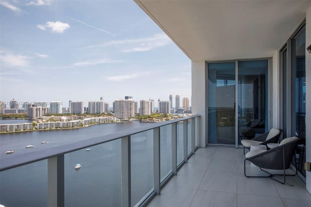 balcony featuring a city view and a water view