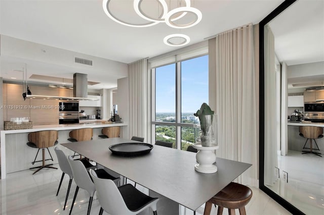 dining room featuring expansive windows and visible vents