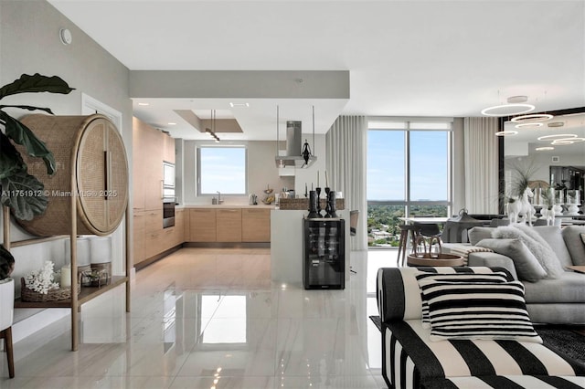 living area with beverage cooler and floor to ceiling windows