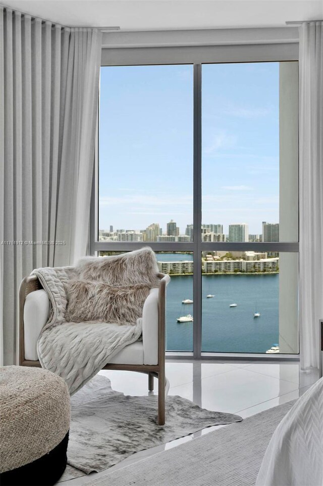 interior space featuring a city view, a water view, and tile patterned floors