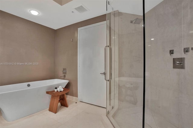 full bath featuring a stall shower, a soaking tub, visible vents, and tile patterned floors