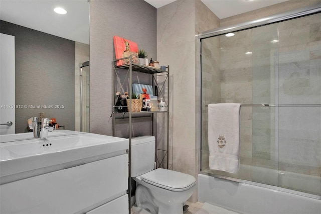 full bathroom with vanity, toilet, and bath / shower combo with glass door