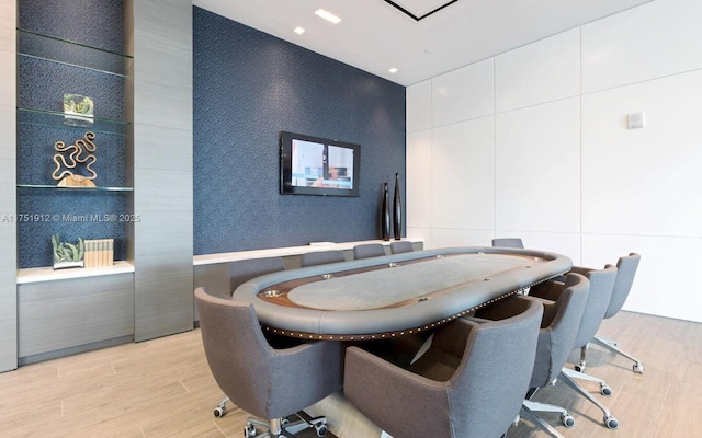 dining space featuring light wood-style floors, recessed lighting, and wallpapered walls