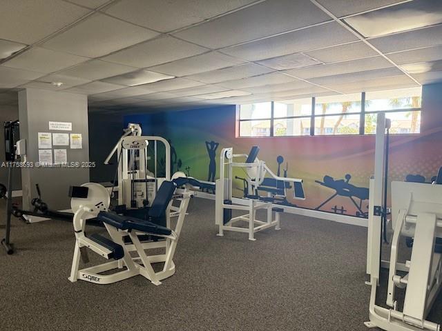 exercise room with a paneled ceiling