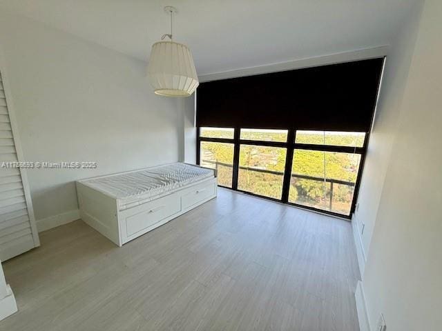 interior space with baseboards and wood finished floors