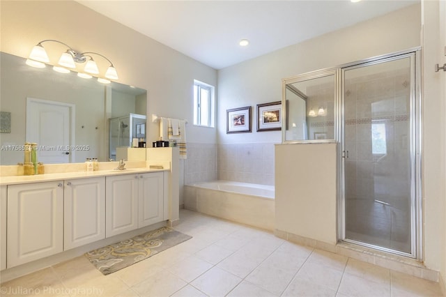 full bathroom with tile patterned floors, a shower stall, vanity, and a bath