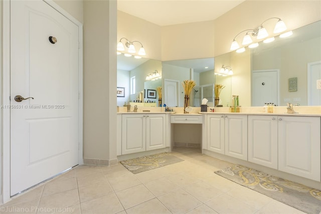 full bathroom with tile patterned flooring, a sink, and double vanity