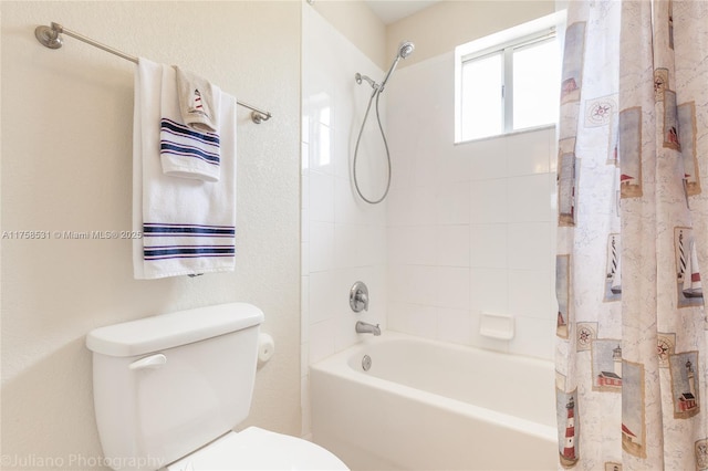 bathroom featuring shower / bath combo and toilet