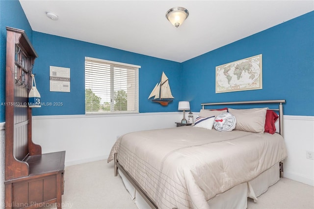 carpeted bedroom featuring baseboards