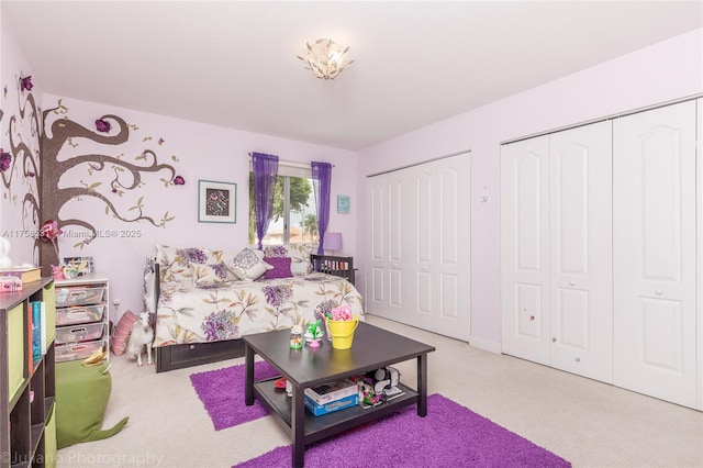 bedroom with carpet and multiple closets