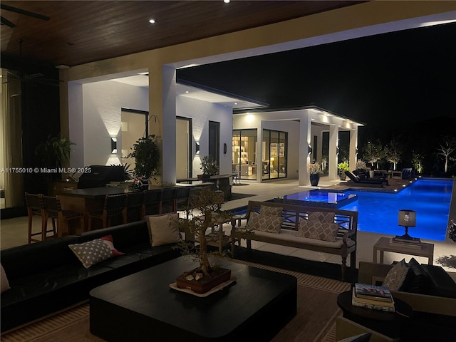 pool at twilight featuring an outdoor living space, outdoor dining area, an outdoor pool, and a patio area