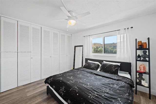 bedroom featuring a closet, ceiling fan, a textured ceiling, and wood finished floors