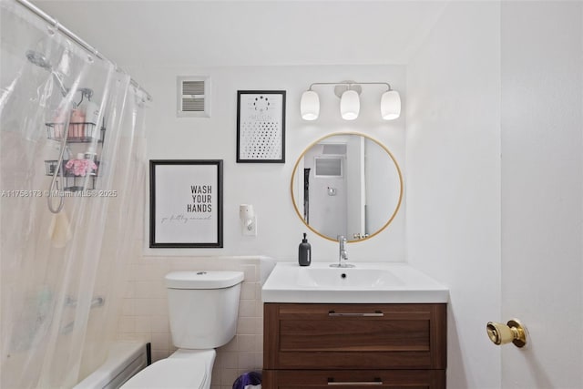 full bathroom with toilet, visible vents, shower / bath combo with shower curtain, and vanity