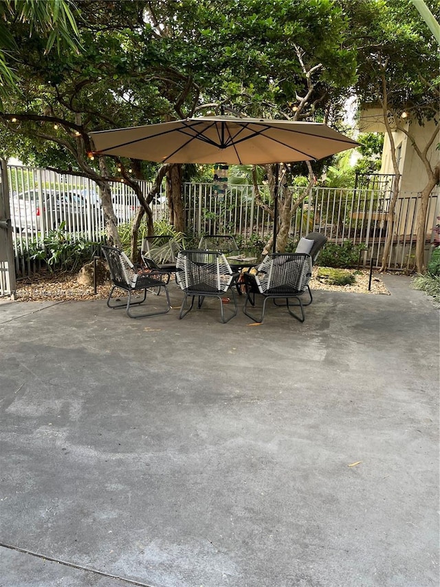 view of patio featuring fence