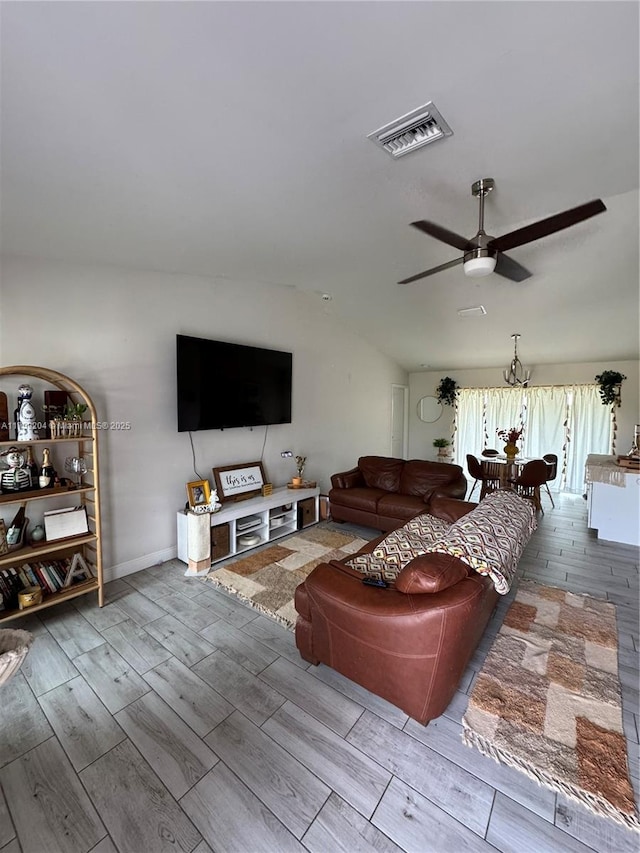 living area with visible vents, lofted ceiling, ceiling fan, and wood tiled floor