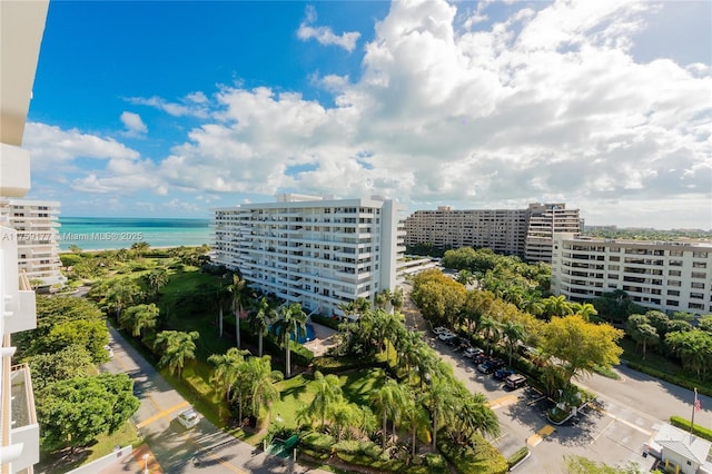 birds eye view of property with a water view and a city view