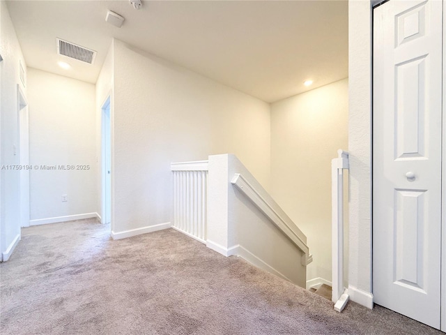 stairway featuring carpet, visible vents, baseboards, and recessed lighting