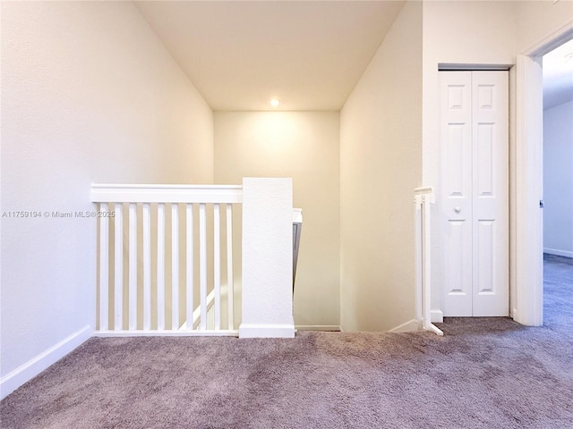 corridor featuring carpet floors and baseboards