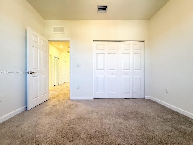 unfurnished bedroom featuring carpet floors, visible vents, and baseboards