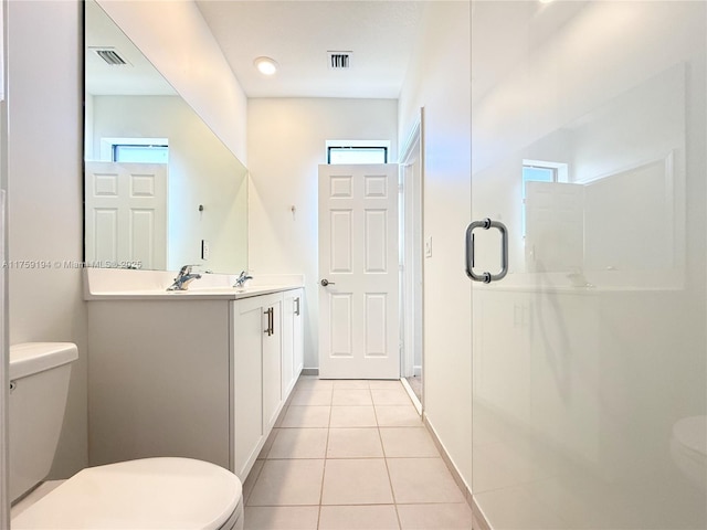 full bathroom featuring tile patterned flooring, toilet, visible vents, vanity, and a shower stall