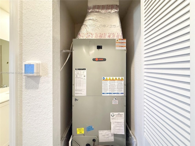 utility room featuring heating unit