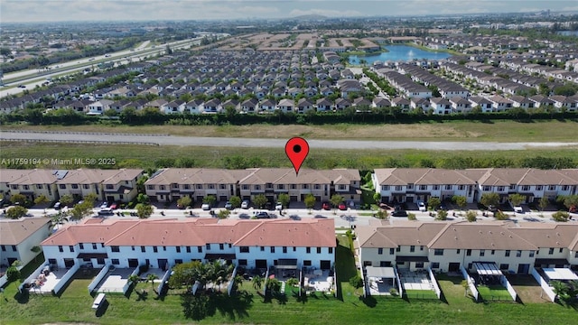 birds eye view of property with a residential view and a water view