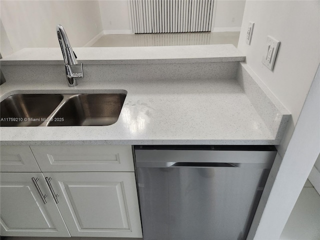 room details featuring a sink, light stone countertops, and stainless steel dishwasher