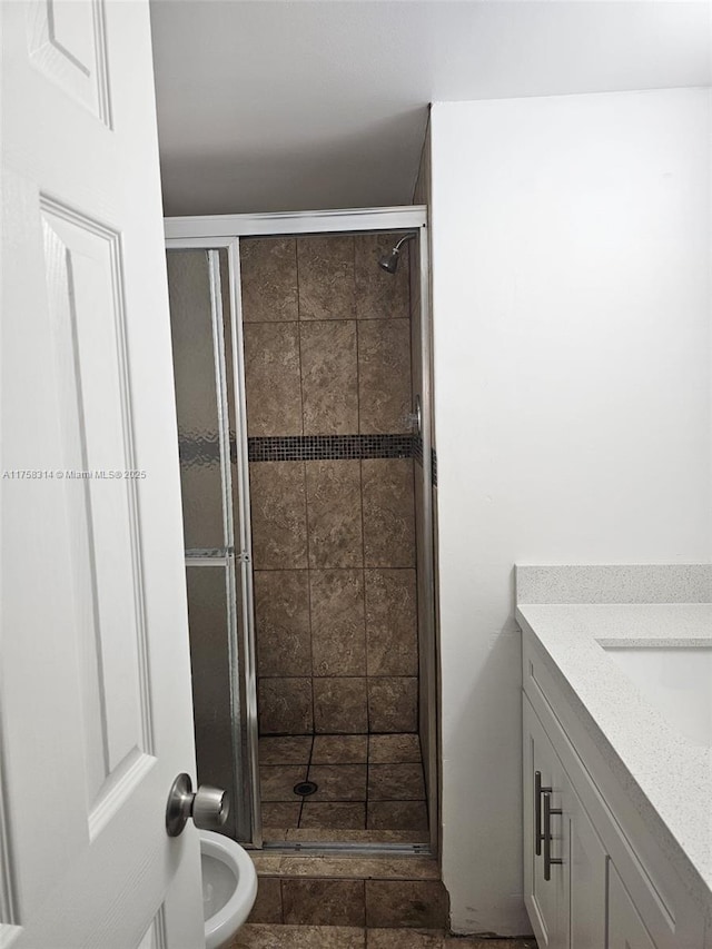 full bath with a stall shower and vanity